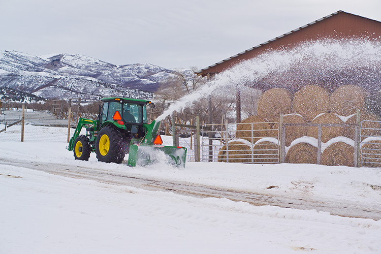 Remove snow from a gravel drive by using a snowblower or rear blade.