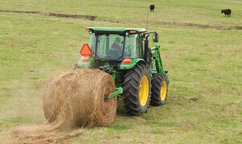 Using a Frontier BU1060 bale unroller to spread a large round bale in a pasture.