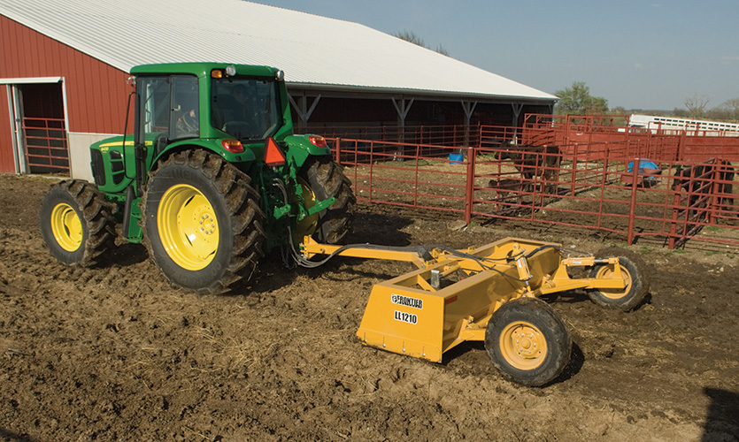 Using a Frontier LL1210 drawn box scraper to remove manure and control drainage in a cattle feed lot.