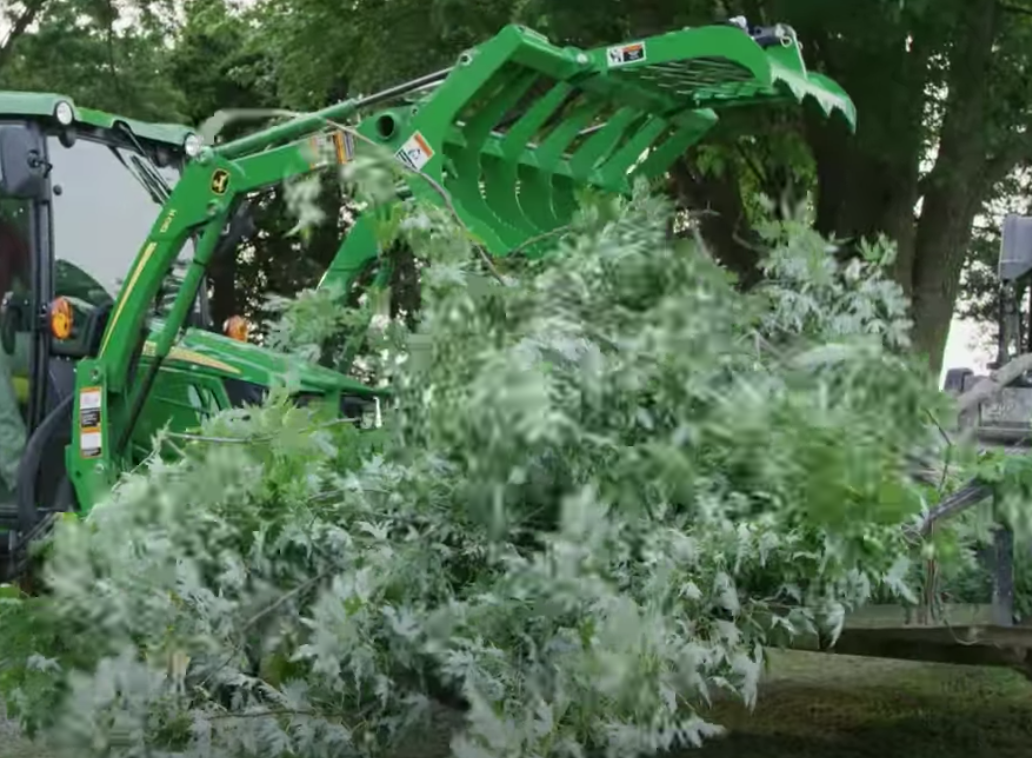 Cleaning up tree branches using a Frontier Root Grapple.