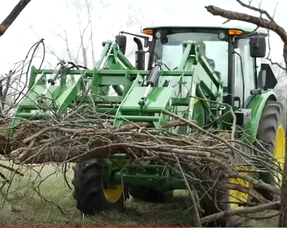 Clearing debris using a Frontier Root Grapple.